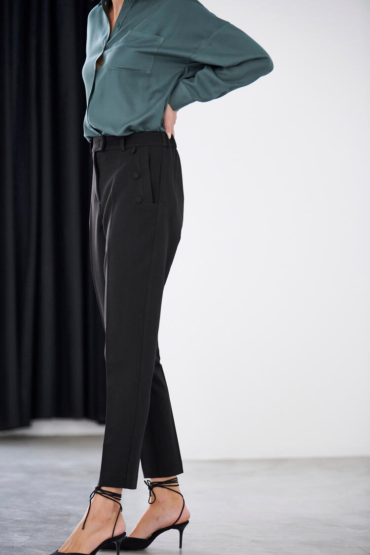Trousers with decorative buttons in the pocket - Black S